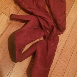 Burgundy over the knee pull on heel boots.